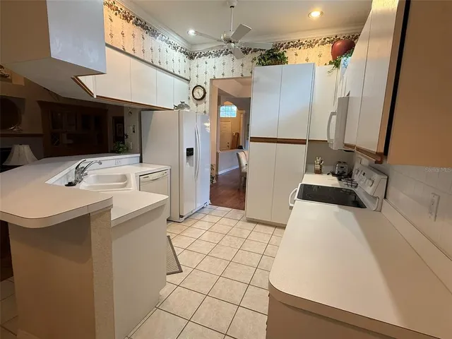 a kitchen with stainless steel appliances a refrigerator and a stove top oven