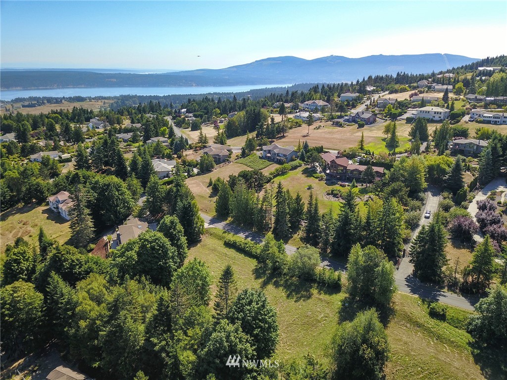 9999 Ravens Ridge Road Sequim, WA 98382 - Photo 6 of 40 an aerial view of residential house with parking and trees