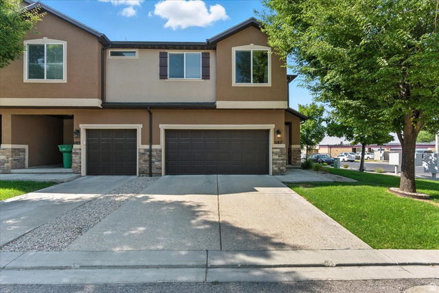 1187 Seraphim Court Layton, UT 84041 - Photo 1 of 18 Traditional-style house with stucco siding, an attached garage, concrete driveway, and stone siding