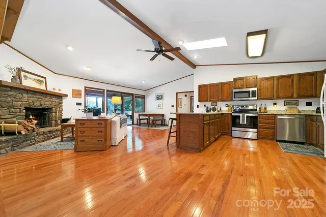 a kitchen with stainless steel appliances wooden floors and refrigerator