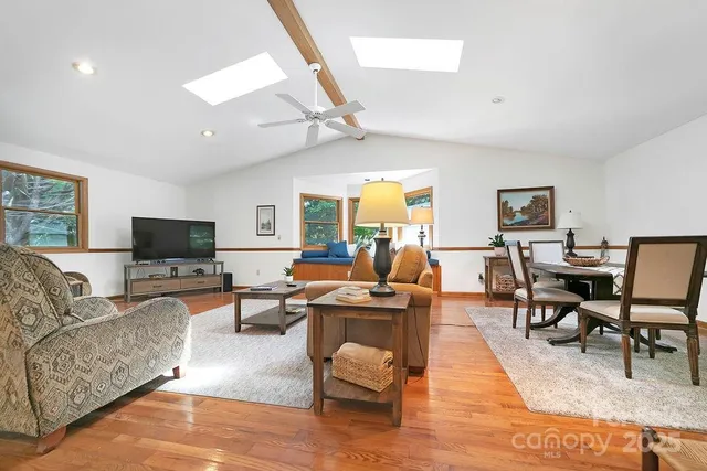 a living room with furniture wooden floor and a flat screen tv