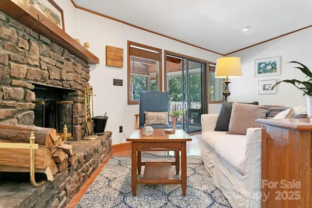 a living room with furniture and a floor to ceiling window