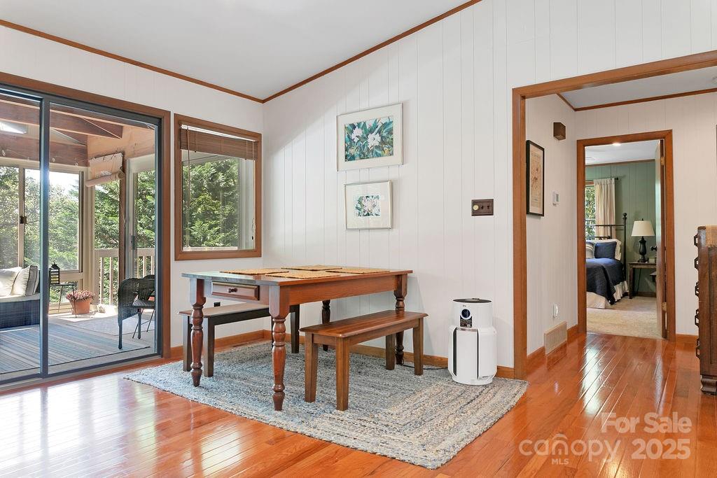 58 Warwaseeta Court Brevard, NC 28712 - Photo 22 of 48 a dining room with wooden floor and a floor to ceiling window