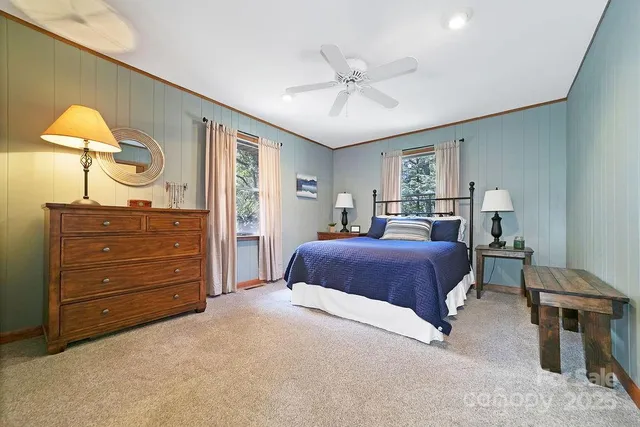 a bedroom with a large bed and a chandelier