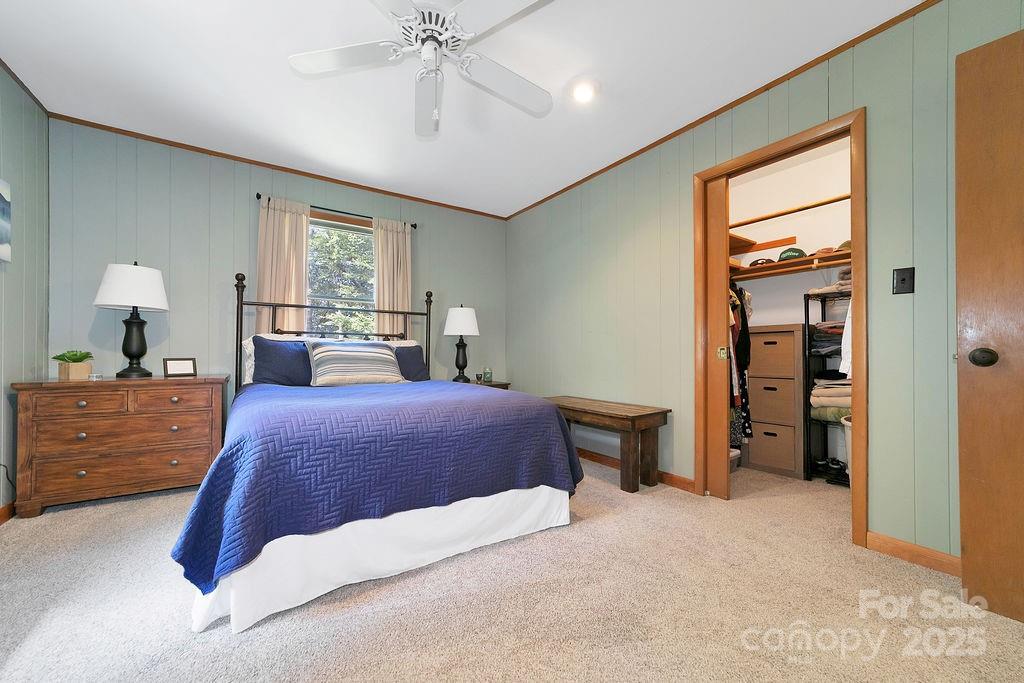 58 Warwaseeta Court Brevard, NC 28712 - Photo 31 of 48 a bedroom with a large bed and a chandelier