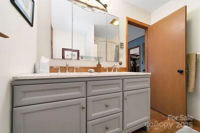 a spacious bedroom with a bed and a chandelier