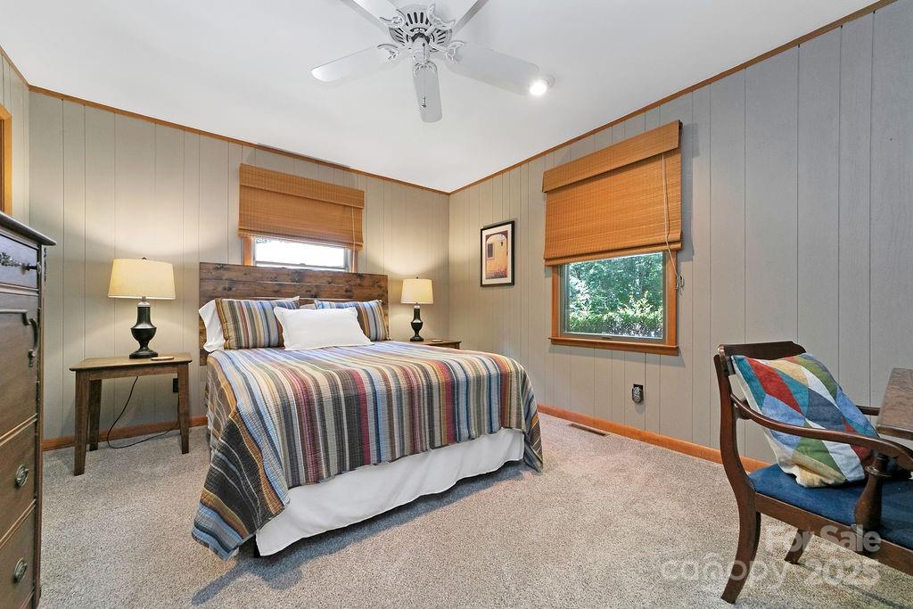 58 Warwaseeta Court Brevard, NC 28712 - Photo 35 of 48 a spacious bedroom with a bed and a chandelier