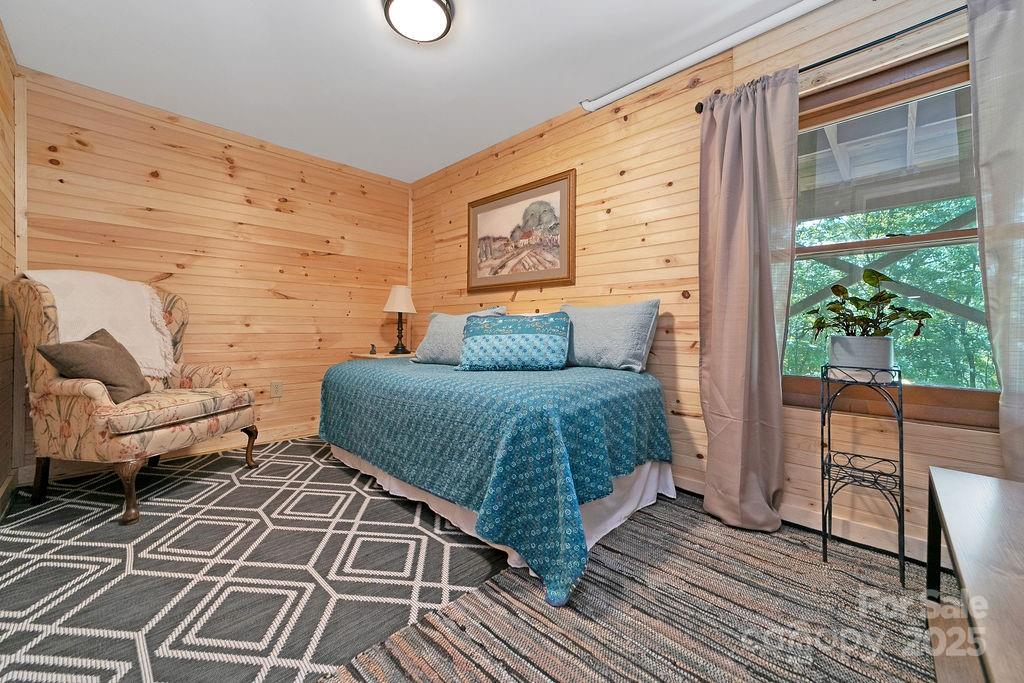 58 Warwaseeta Court Brevard, NC 28712 - Photo 44 of 48 a bedroom with a bed and wooden floor