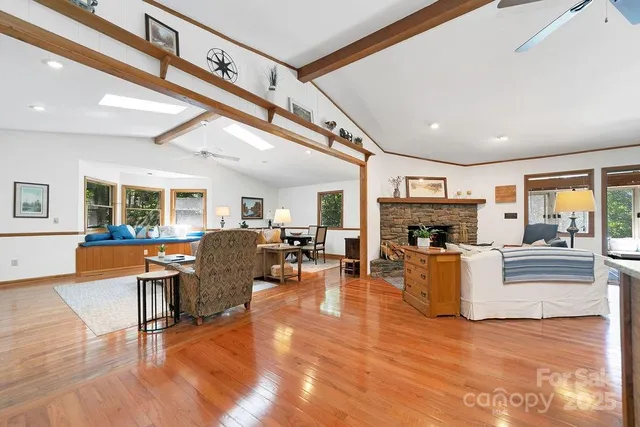 a living room with furniture a fireplace and a flat screen tv
