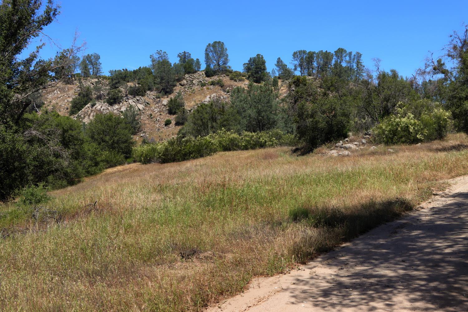 80 Polk Ranch Road Coarsegold, CA 93614 - Photo 13 of 31 a view of a road with a building in the background