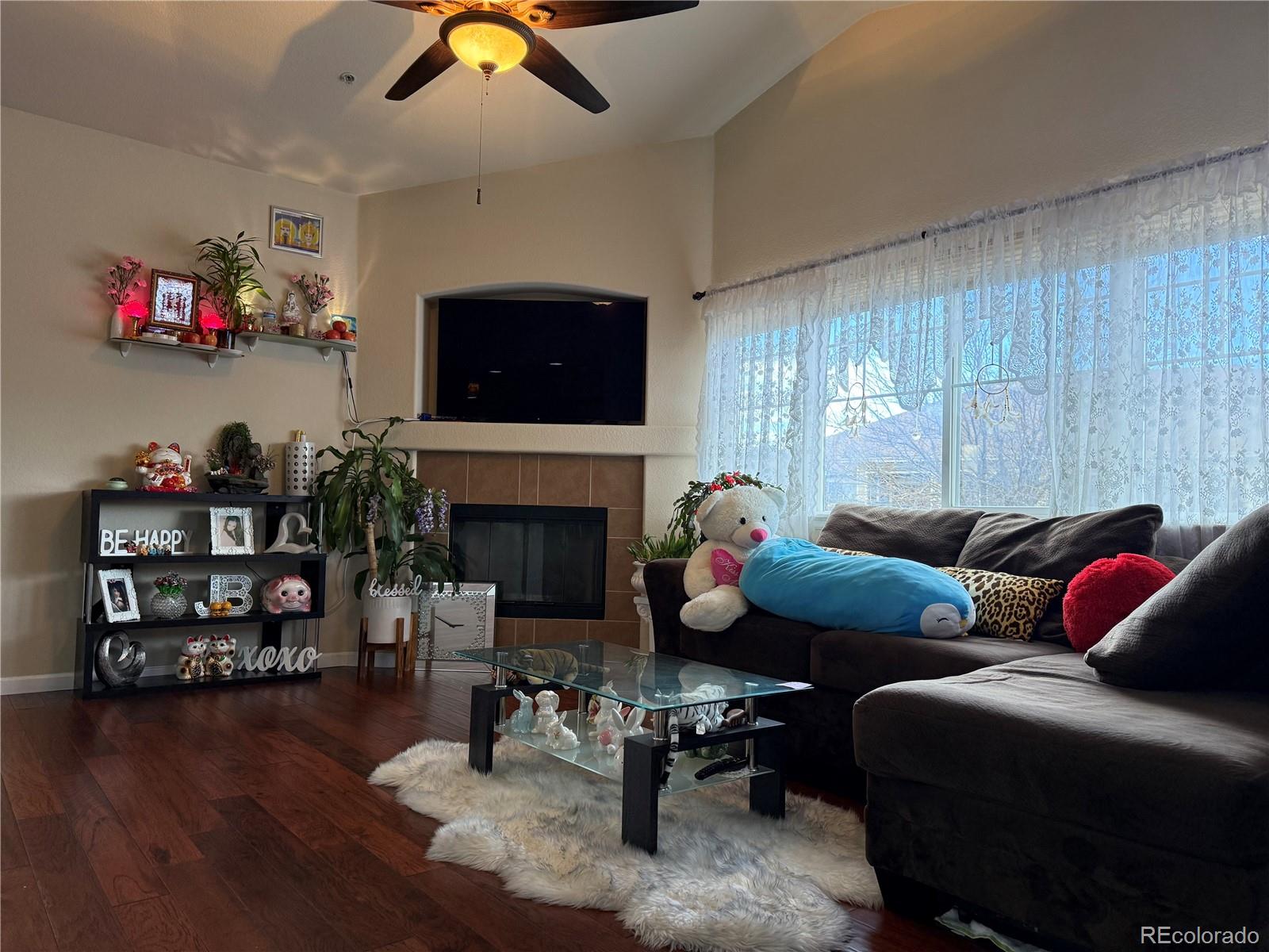 6292 Kilmer Loop, Unit 204 Golden, CO 80403 - Photo 12 of 27 a living room with furniture a fireplace and a flat screen tv