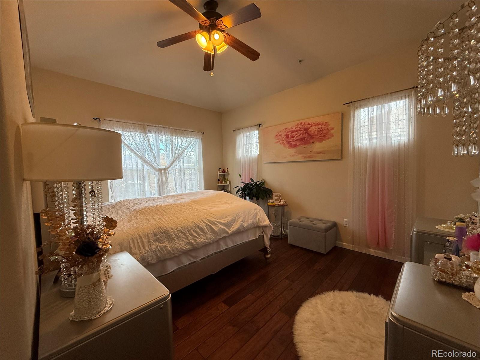 6292 Kilmer Loop, Unit 204 Golden, CO 80403 - Photo 16 of 27 a bedroom with a bed and a chandelier