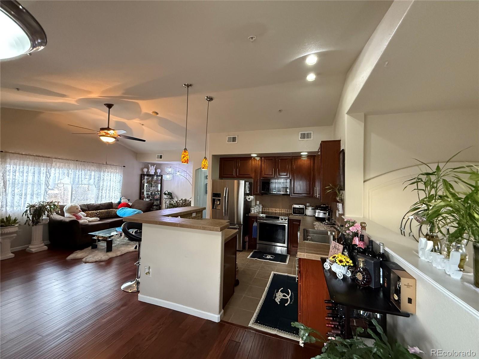 6292 Kilmer Loop, Unit 204 Golden, CO 80403 - Photo 5 of 27 a kitchen with sink refrigerator and microwave