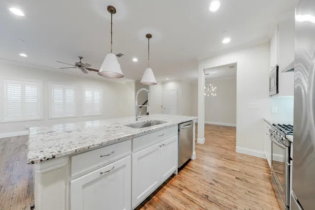 a bathroom with a granite countertop sink a toilet and a large mirror