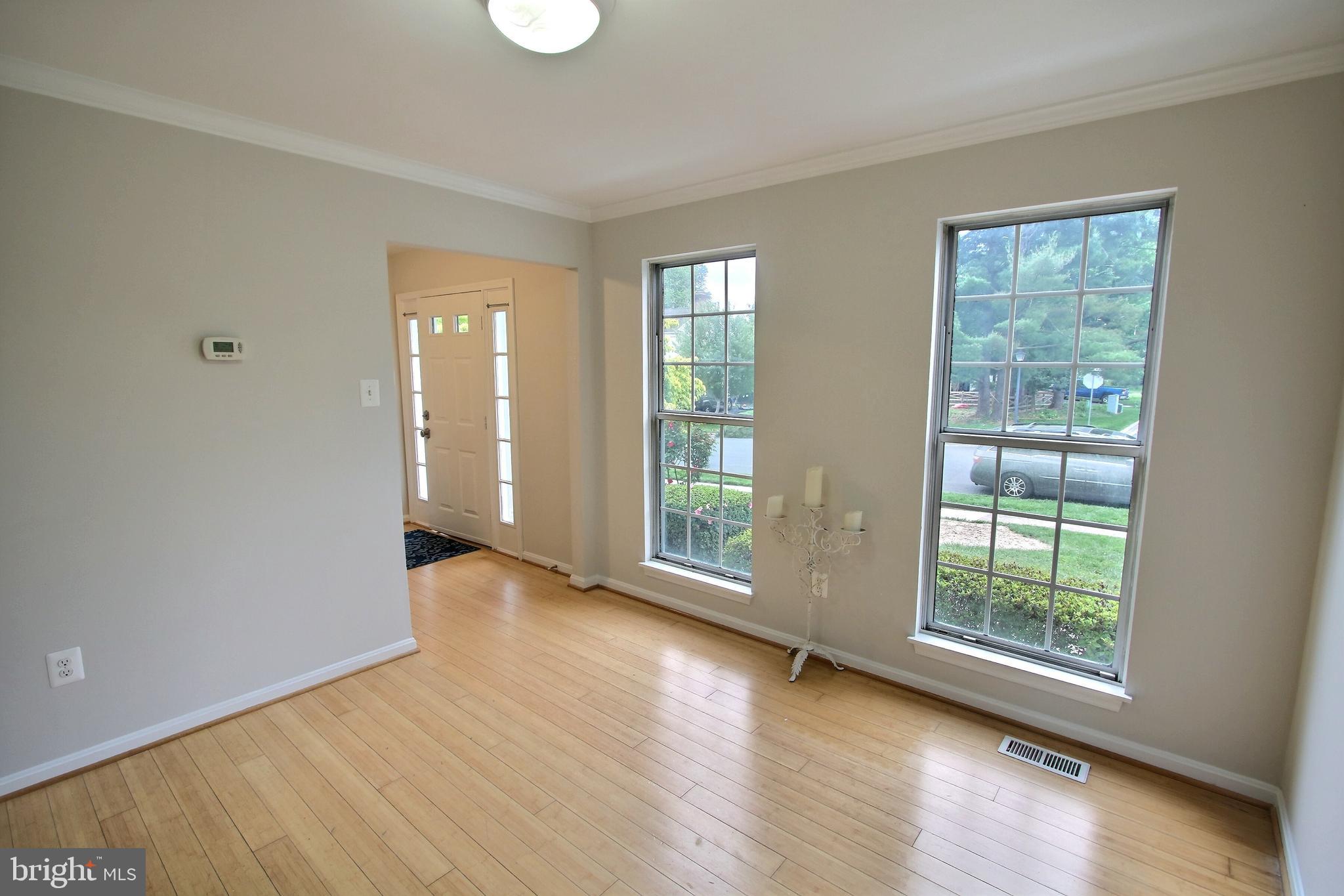 813 Pointer Ridge Drive Gaithersburg, MD 20878 - Photo 11 of 43 a view of an empty room with wooden floor and a window