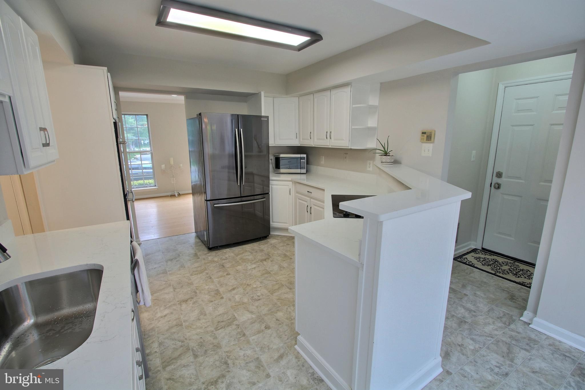 813 Pointer Ridge Drive Gaithersburg, MD 20878 - Photo 14 of 43 a kitchen with a refrigerator sink and stove