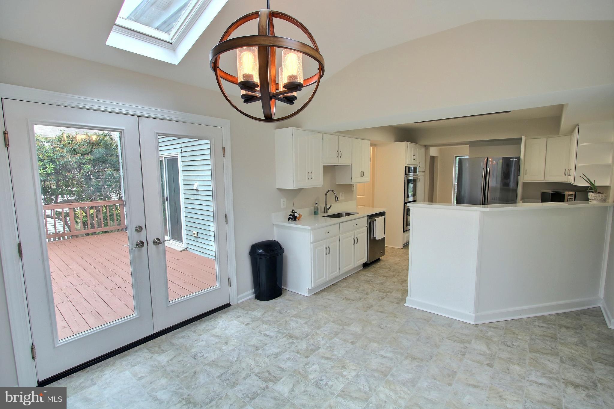 813 Pointer Ridge Drive Gaithersburg, MD 20878 - Photo 17 of 43 a view of a kitchen with a dishwasher and a large window