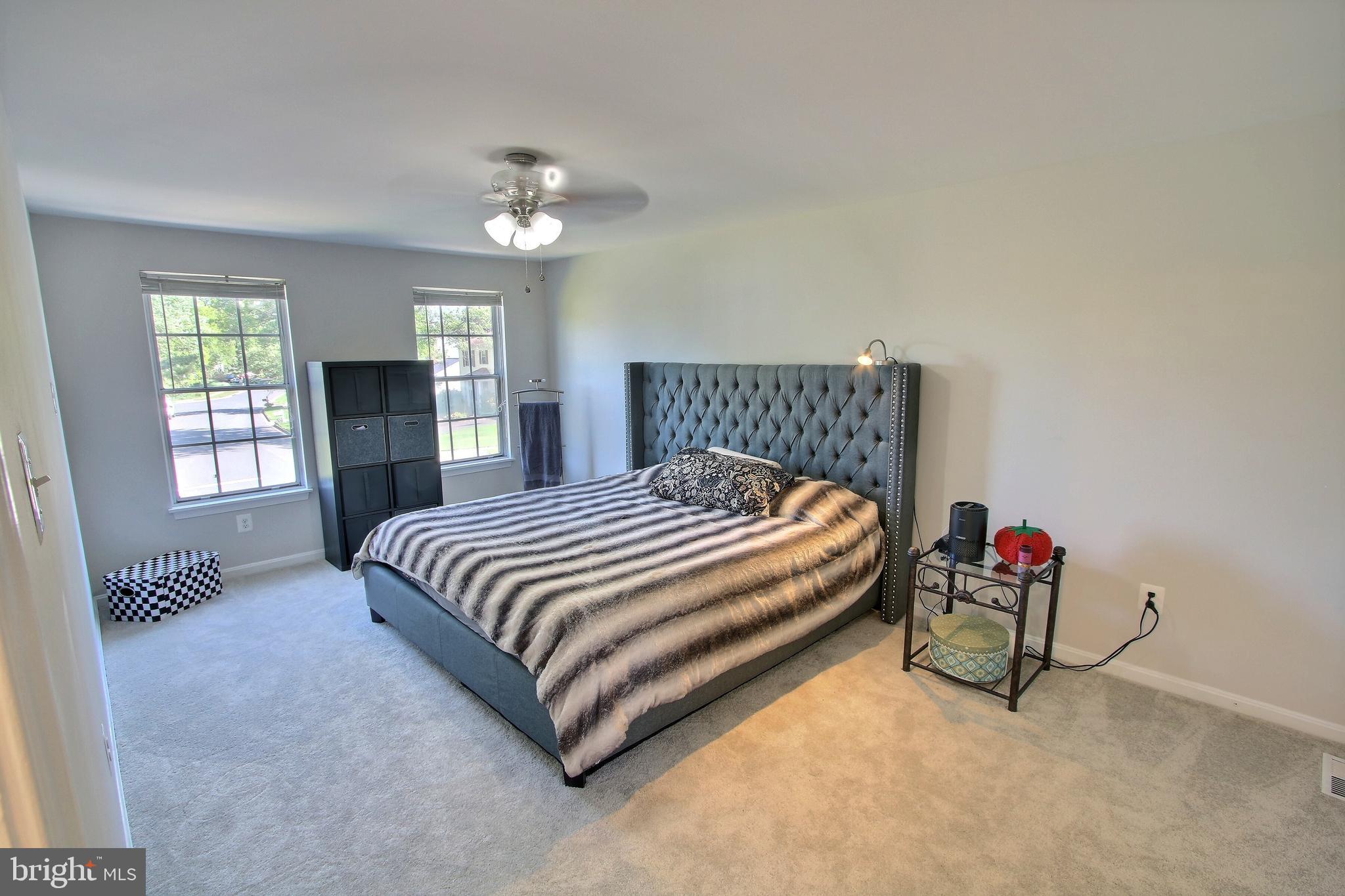 813 Pointer Ridge Drive Gaithersburg, MD 20878 - Photo 25 of 43 a bedroom with a bed and a chandelier