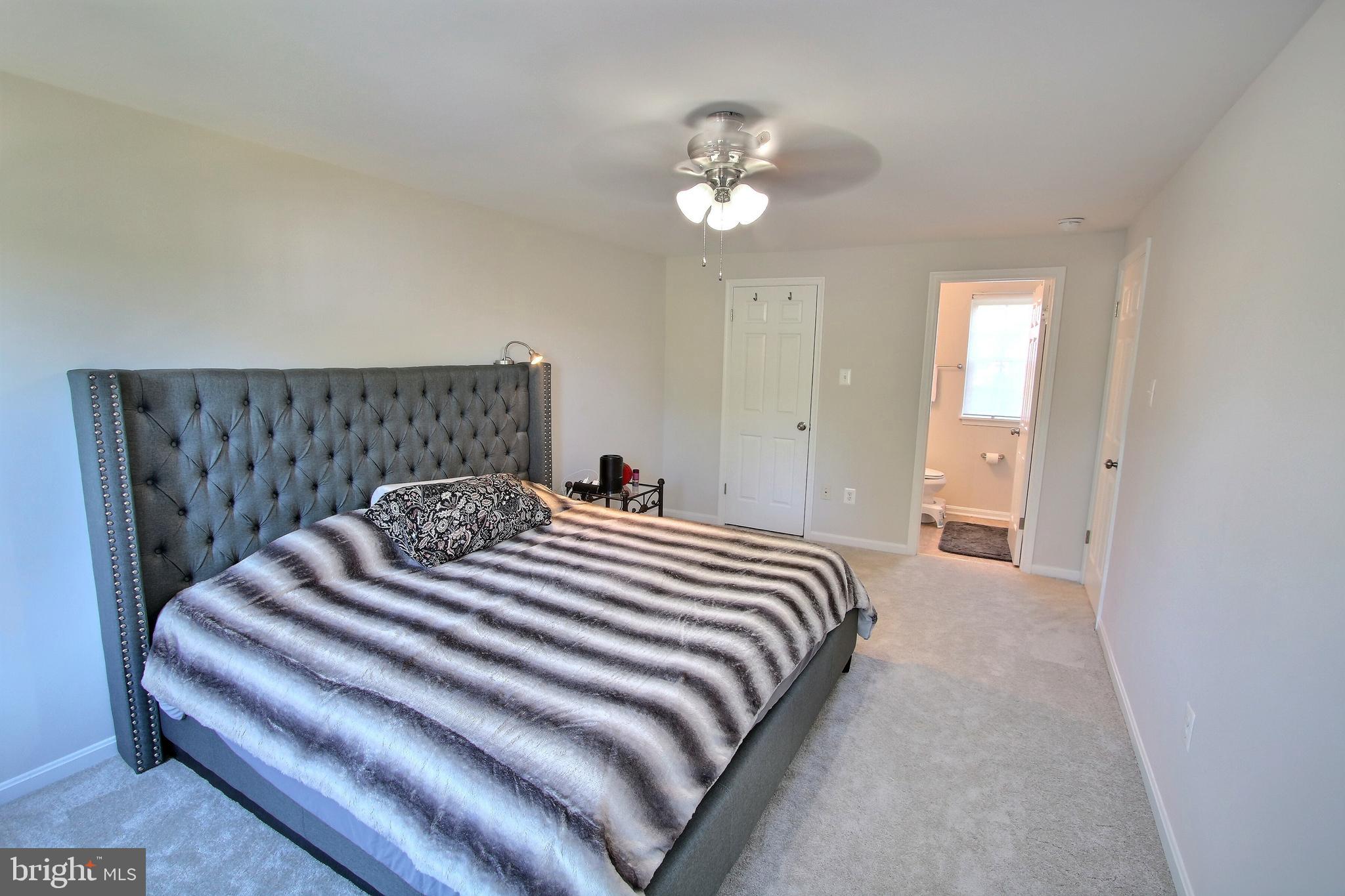 813 Pointer Ridge Drive Gaithersburg, MD 20878 - Photo 26 of 43 a bedroom with a bed and a chandelier