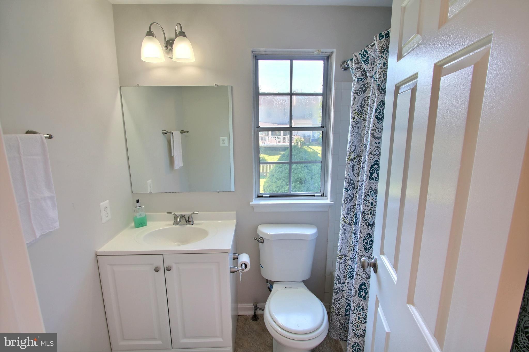 813 Pointer Ridge Drive Gaithersburg, MD 20878 - Photo 33 of 43 a bathroom with a toilet sink and mirror