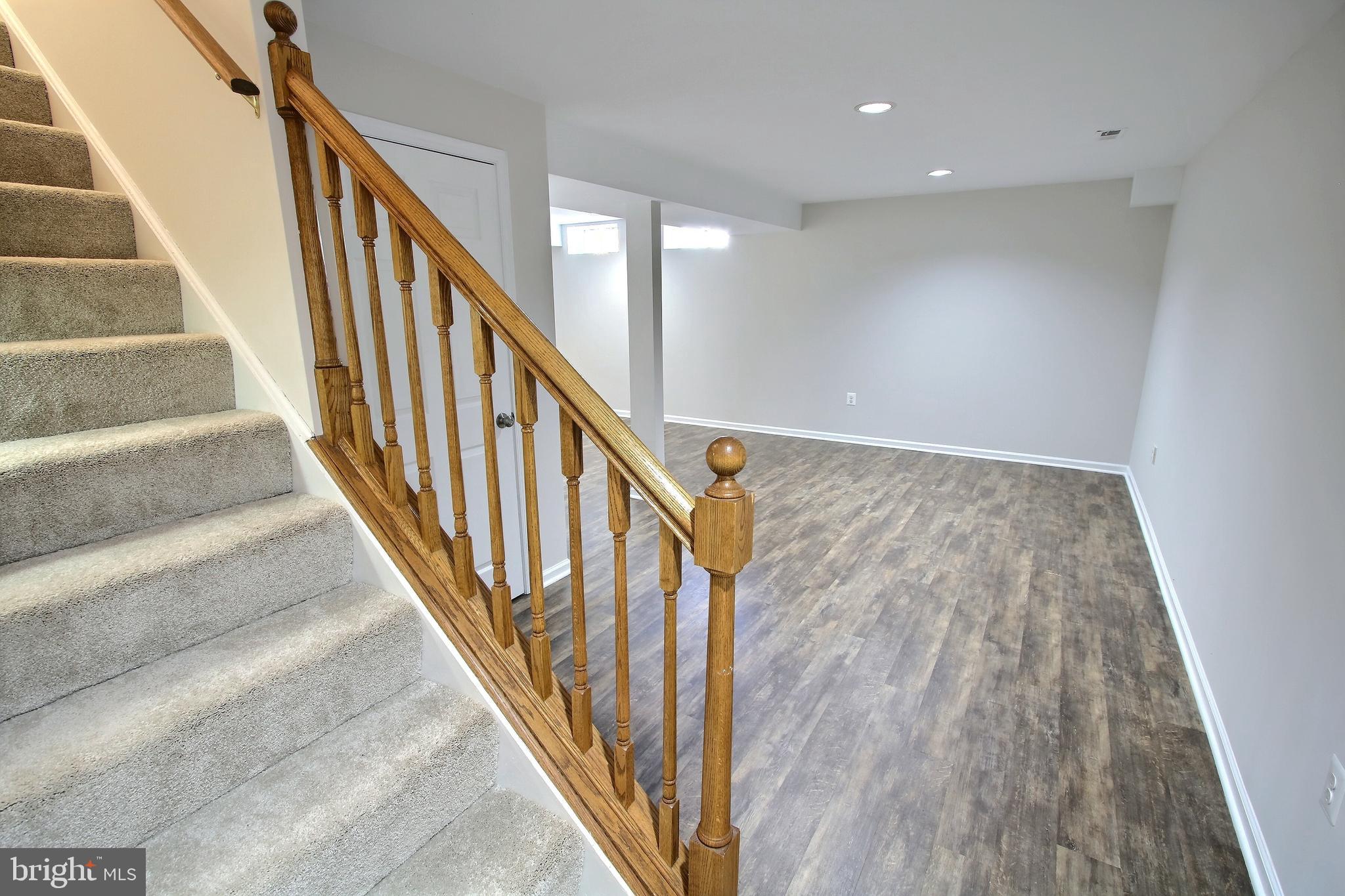 813 Pointer Ridge Drive Gaithersburg, MD 20878 - Photo 34 of 43 a view of staircase with wooden floor and white walls