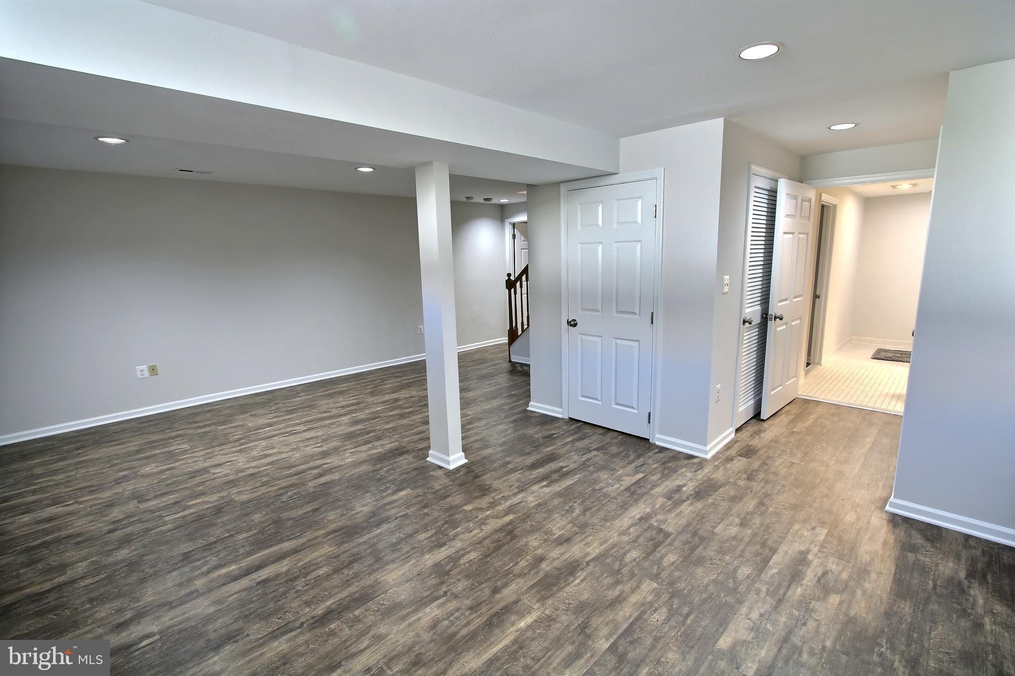 813 Pointer Ridge Drive Gaithersburg, MD 20878 - Photo 36 of 43 an empty room with wooden floor and windows