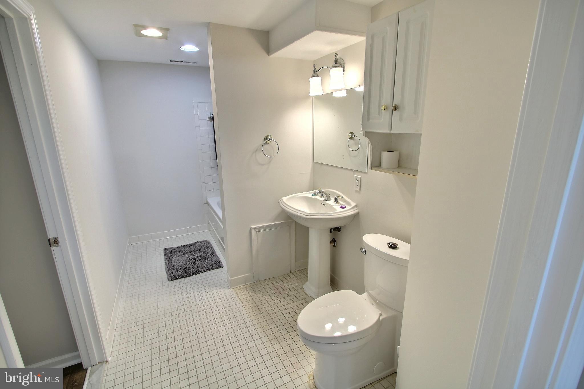 813 Pointer Ridge Drive Gaithersburg, MD 20878 - Photo 39 of 43 a bathroom with a sink toilet and shower