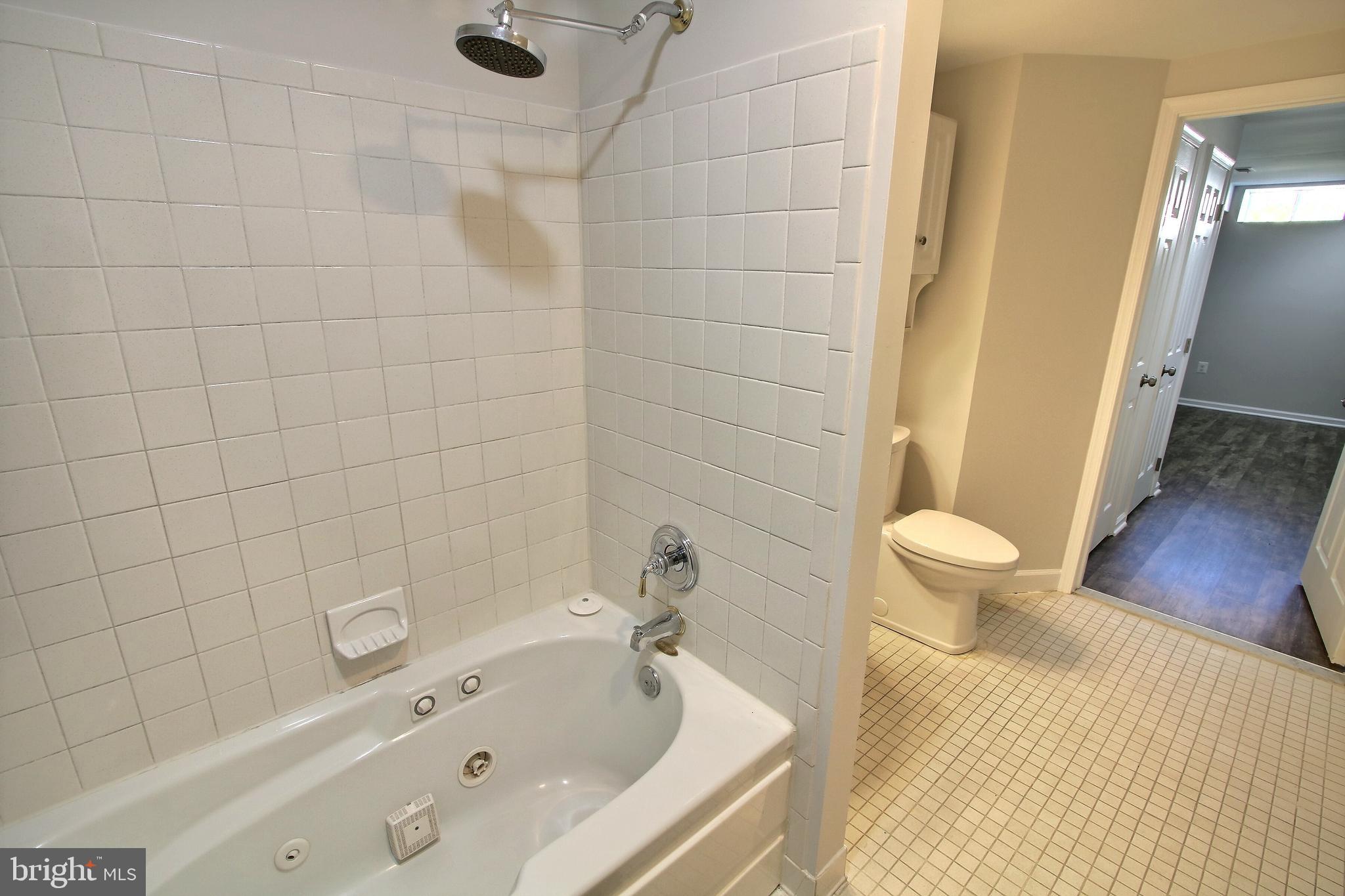 813 Pointer Ridge Drive Gaithersburg, MD 20878 - Photo 40 of 43 a bathroom with a tub and a toilet