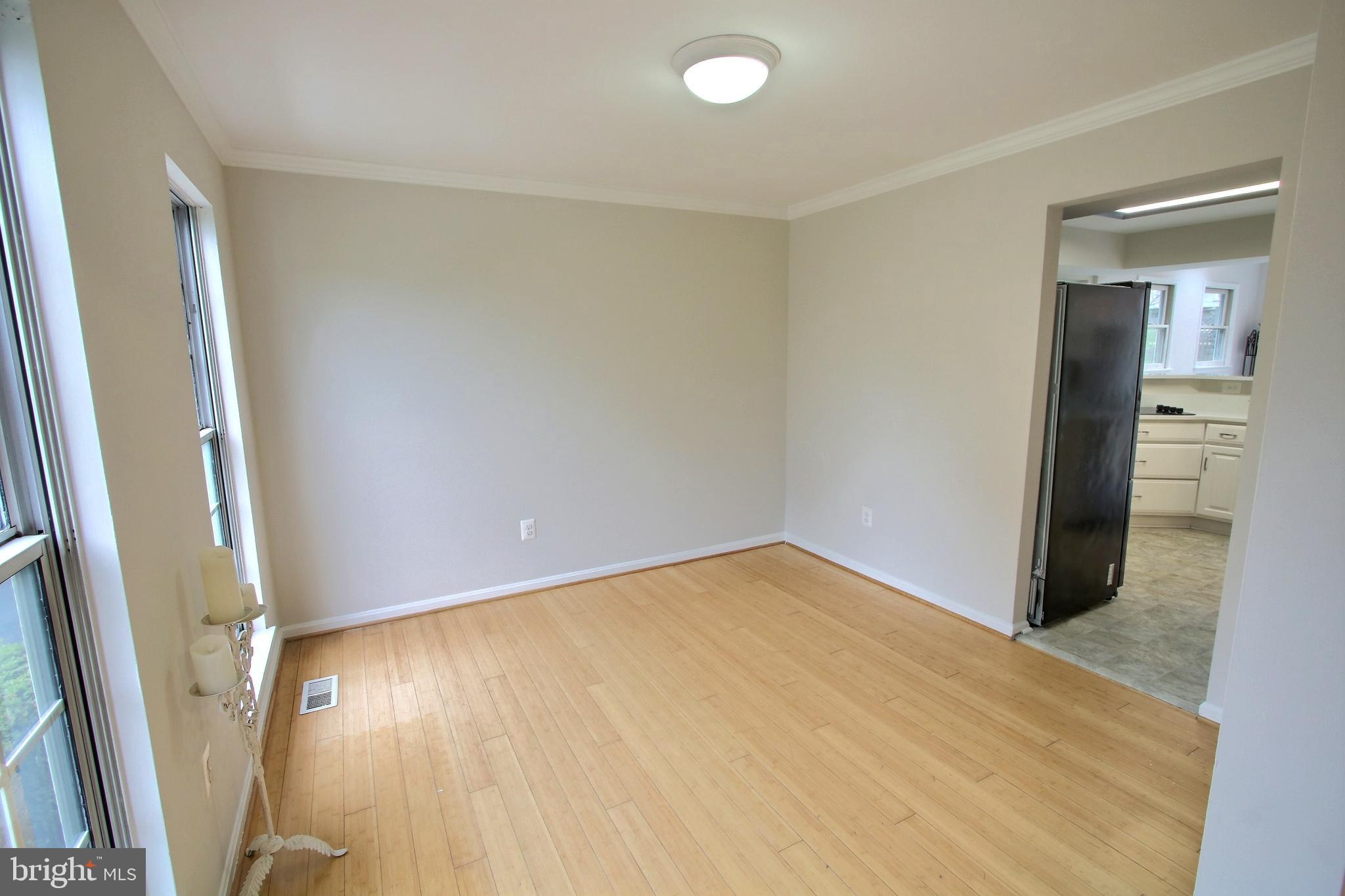 813 Pointer Ridge Drive Gaithersburg, MD 20878 - Photo 9 of 43 wooden floor in an empty room with a window
