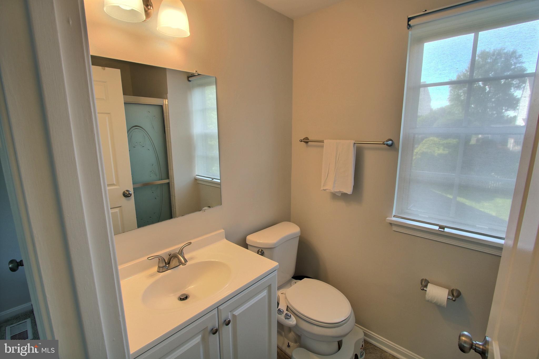 813 Pointer Ridge Drive Gaithersburg, MD 20878 - Photo 10 of 43 a bathroom with a sink mirror vanity and toilet