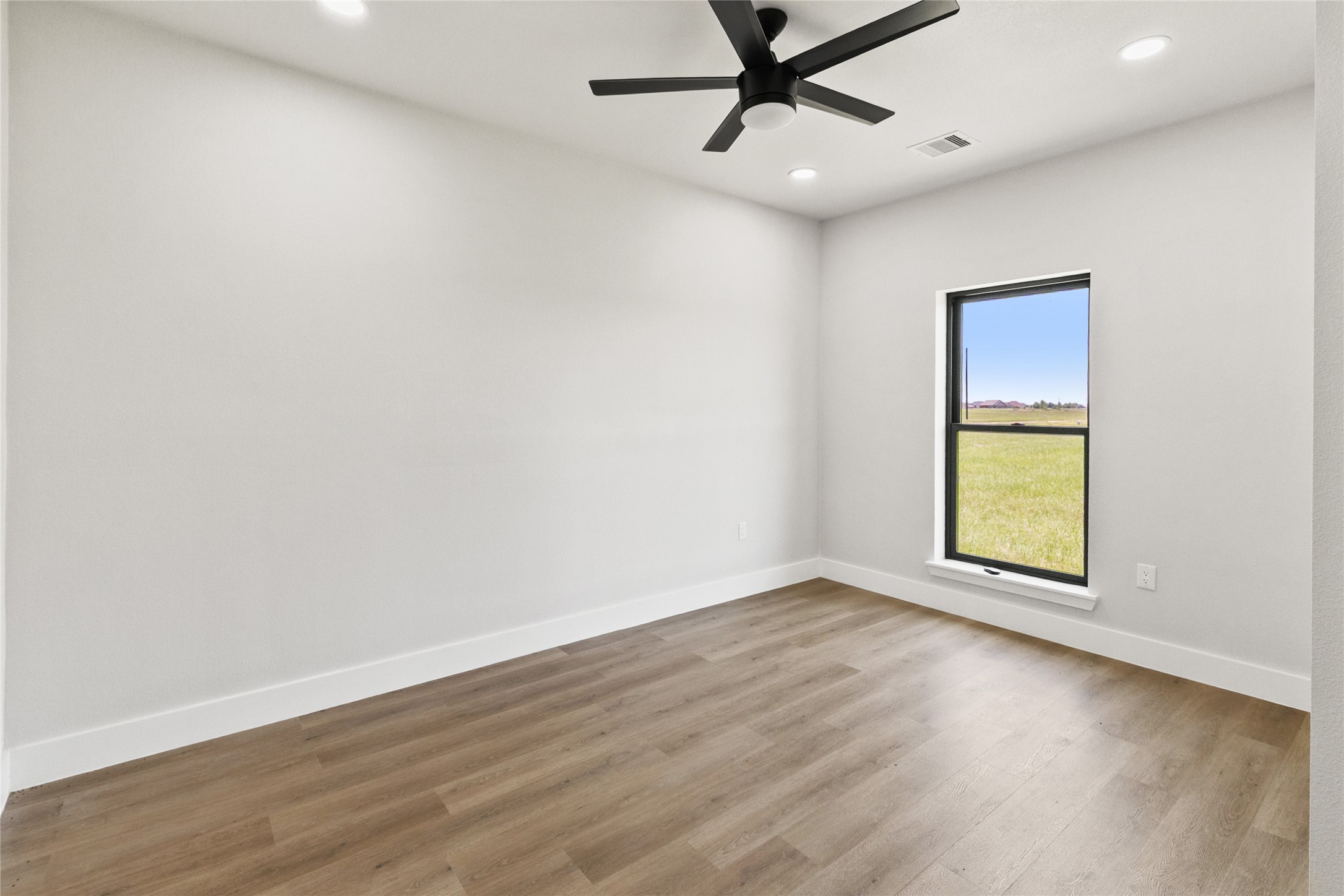 619 Chuckwagon Trail Angleton, TX 77515 - Photo 27 of 37 Secondary bedroom with a closet and convenient access to the full guest bathroom. Natural light and neutral finishes provide a comfortable space for guests, family, or a home office.