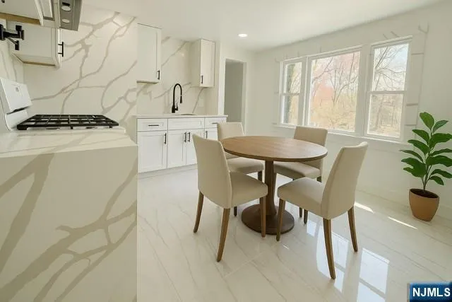 a view of a dining room with furniture and a potted plant