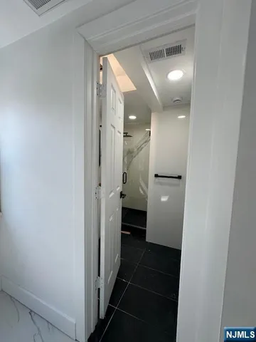 a view of a hallway with a bathroom