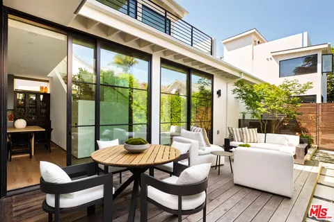 a view of a patio with a dining table and chairs