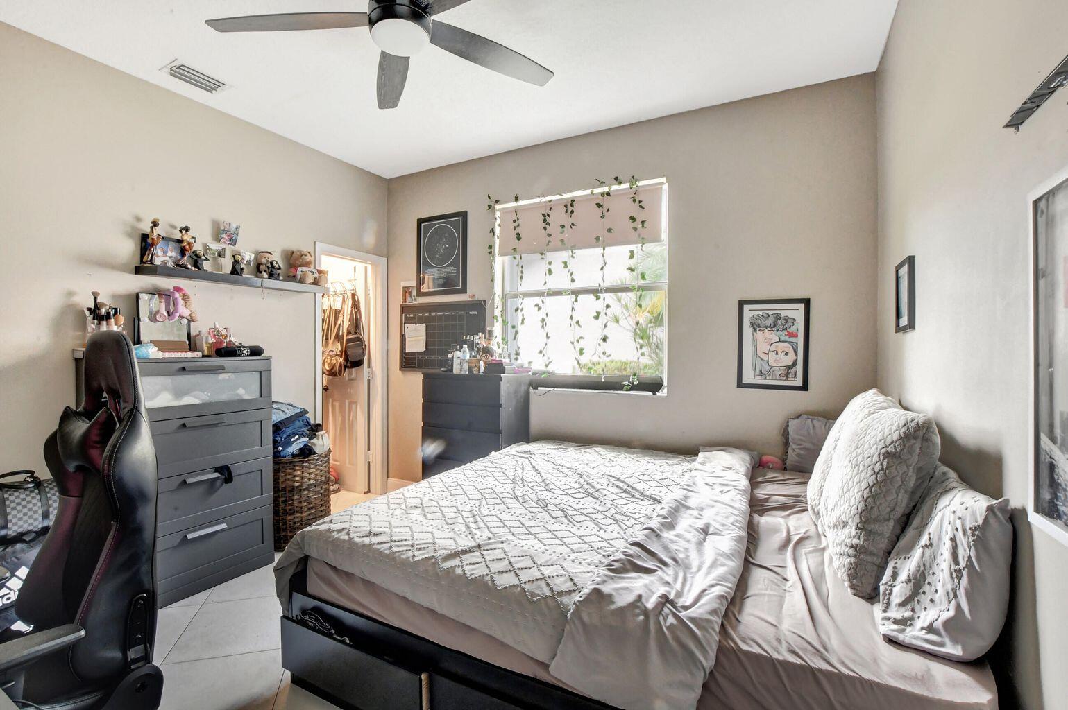 12364 Clearfalls Drive Boca Raton, FL 33428 - Photo 13 of 32 a bedroom with a bed and dresser