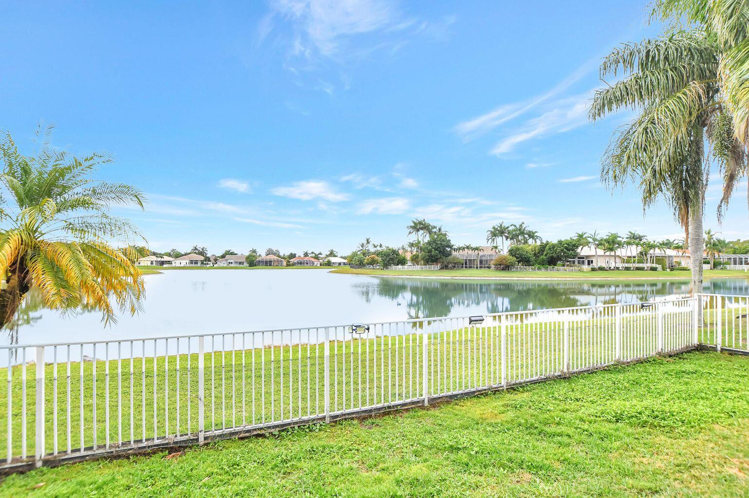 12364 Clearfalls Drive Boca Raton, FL 33428 - Photo 17 of 32 a view of a lake with a big yard and potted plants