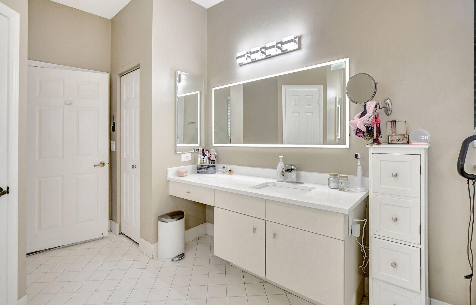 12364 Clearfalls Drive Boca Raton, FL 33428 - Photo 9 of 32 a spacious bathroom with a sink double vanity and mirror
