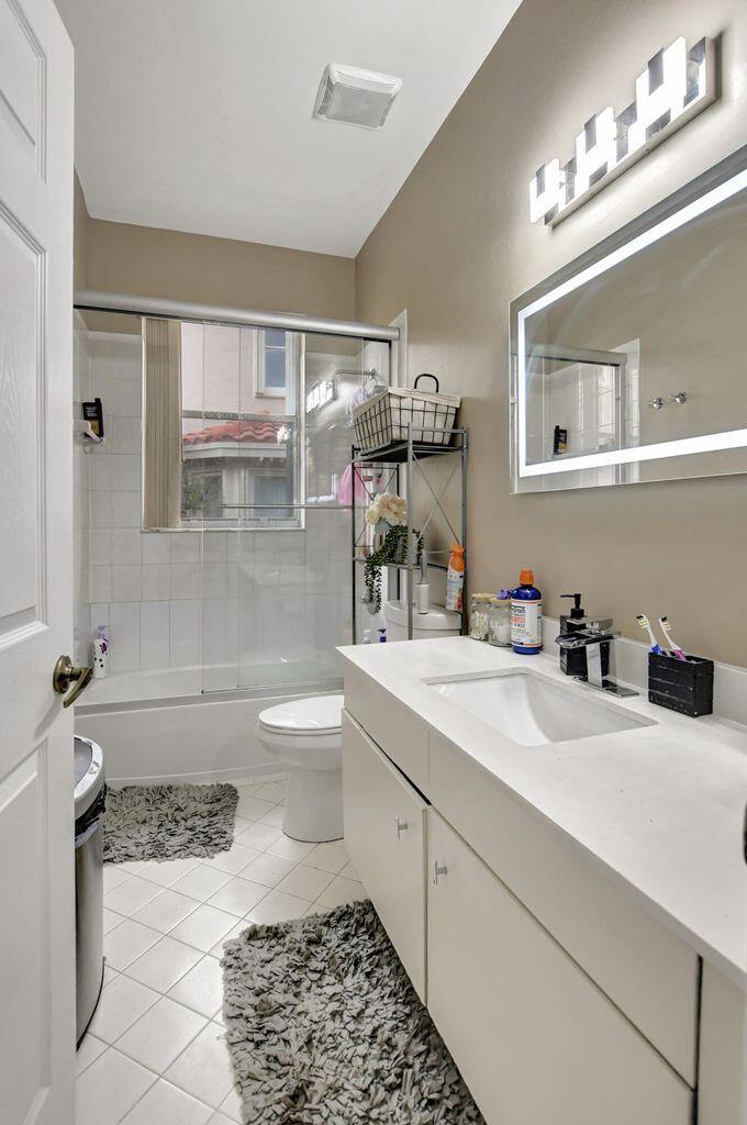 12364 Clearfalls Drive Boca Raton, FL 33428 - Photo 10 of 32 a bathroom with a sink a toilet and shower