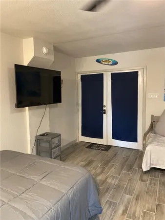 a bedroom with a bed and a flat screen tv
