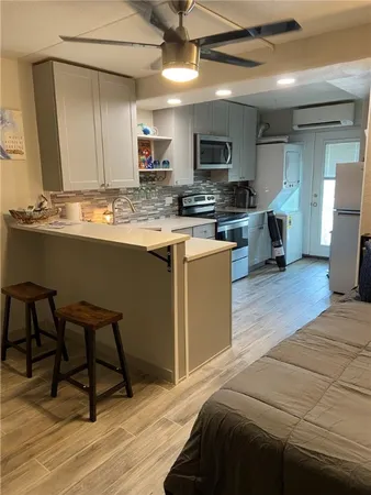 a kitchen with stainless steel appliances granite countertop a sink wooden cabinets and granite counter tops