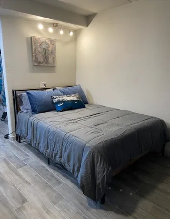 a bedroom with a bed and a night stand