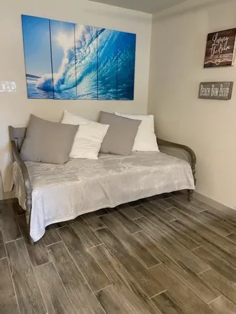 a bedroom with a bed and a painting on the wall