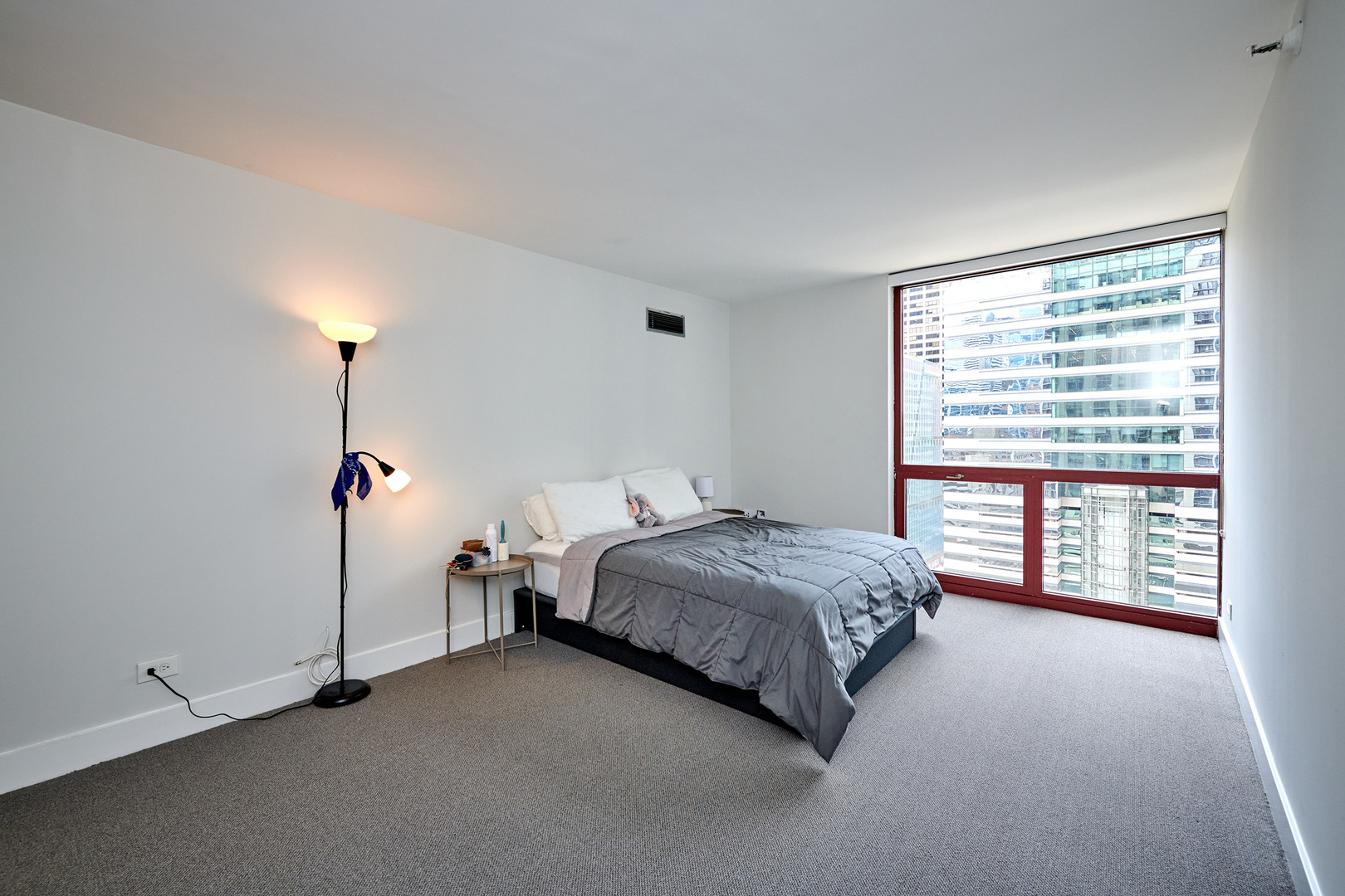 200 North Dearborn Street, Unit 1808 Chicago, IL 60601 - Photo 21 of 32 a bedroom with a bed and a window
