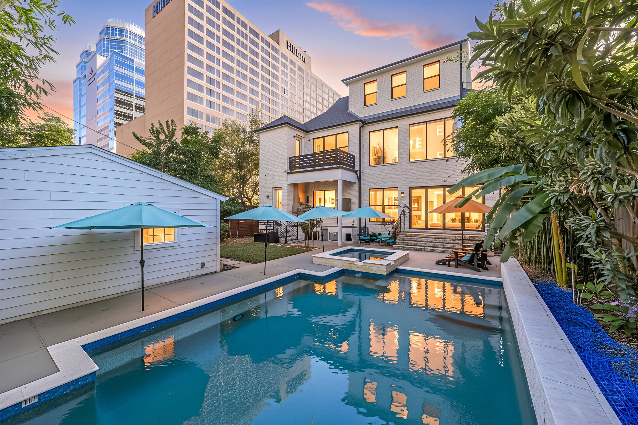 a view of a house with backyard and sitting area