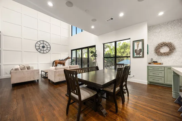 a dining room with furniture and wooden floor