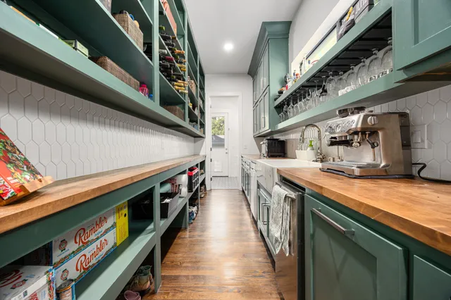a hallway with stainless steel appliances granite countertop lots of counter space