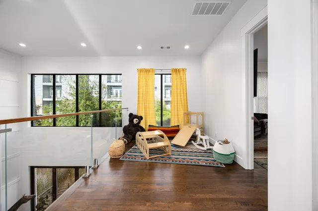 a living room with furniture and large windows