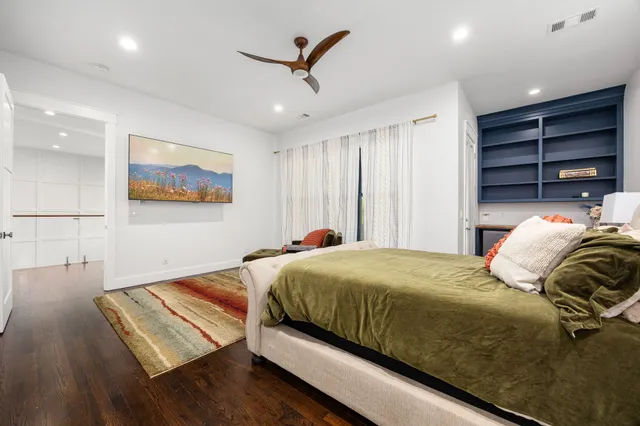 a bedroom with a bed and a painting