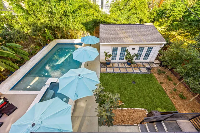 a view of a house with backyard and sitting area