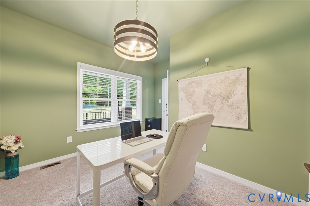 7598 Rural Point Road Mechanicsville, VA 23116 - Photo 18 of 41 a view of a dining room with furniture and chandelier